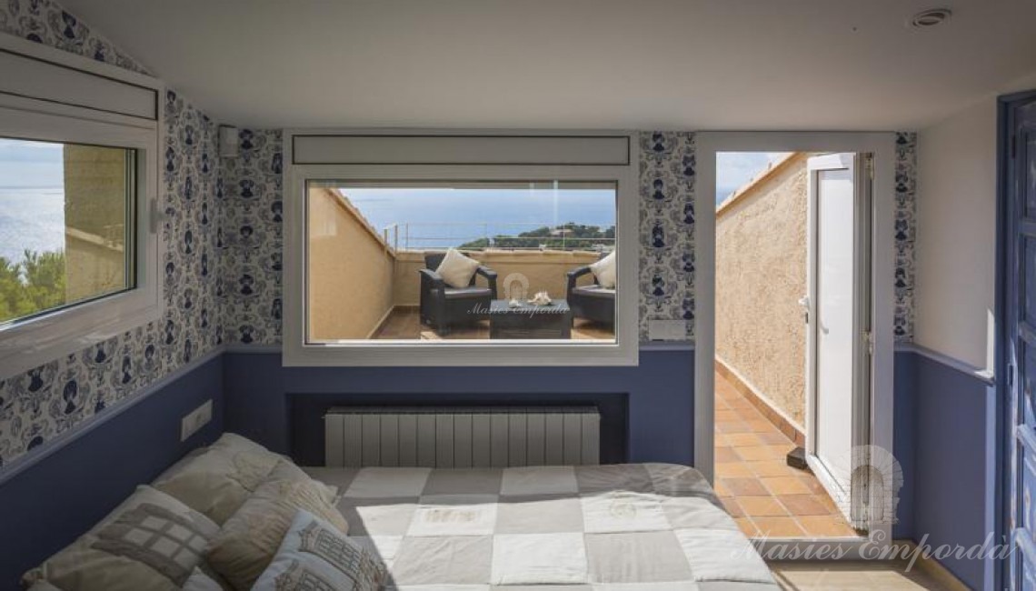 Perspectiva de un de las suites de la casa con la terraza privada al fondo con vistas a la calas y al mar. 